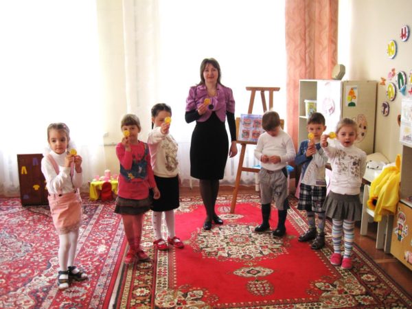 Дети и педагог держат в руках жёлтые смайлики