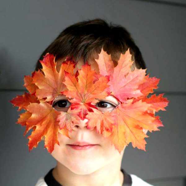 Мальчик в маске из осенних листьев