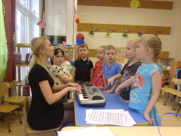 Педагог играет детям на электронном пианино