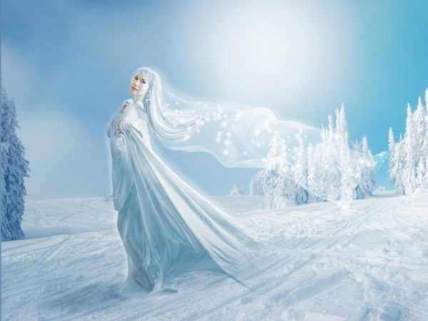 Зима в образе красавицы окутывает землю снежным покрывалом