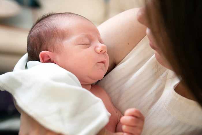 Новорожденный спит у мамы на руках